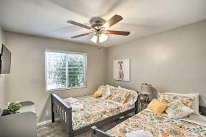 a bedroom with two beds and a ceiling fan at Stylish and Central Mesa Home with Private Pool! in Mesa +30 photos