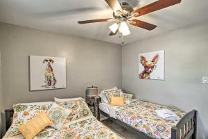 a bedroom with two beds and a ceiling fan at Stylish and Central Mesa Home with Private Pool! in Mesa