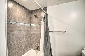 a bathroom with a shower and a tub at Stylish and Central Mesa Home with Private Pool! in Mesa