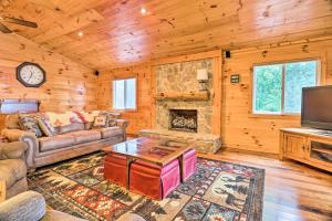- un salon avec un canapé et une cheminée dans l'établissement Cozy Cullowhee Cabin with Breathtaking Views!, à Glenville