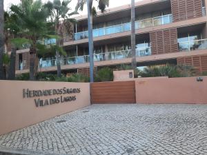 a building with a sign in front of it at Salgados by The Beach in Albufeira
