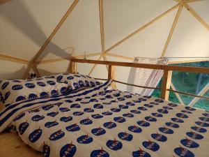 a bed in a room with a canopy at Młyn Hipolit glamping in Nowy Gaj