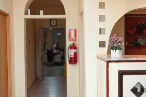 a hallway of a hospital with a fire extinguisher at AIDA Hotel spa & tratament in Geoagiu Băi