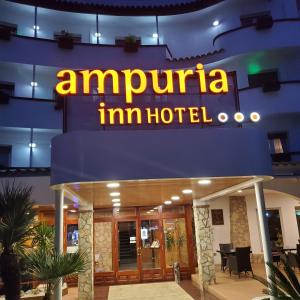 
a hotel lobby with a sign for a restaurant at Ampuria Inn in Empuriabrava
