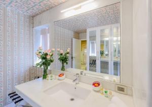 a bathroom with a sink and a mirror at Surya Haveli , Amer Fort Jaipur in Jaipur