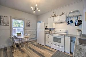 a kitchen with white appliances and a table with chairs at Bright Laramie Home with Backyard and Fire Pit in Laramie