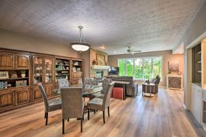 a living room with a table and chairs and a couch at Resort-Style Condo with Balcony on Lake Keowee in Salem