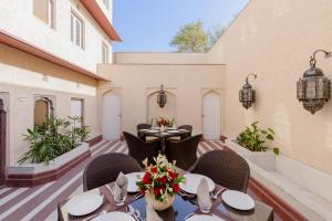 a dining room with tables and chairs on a patio at Surya Haveli , Amer Fort Jaipur in Jaipur