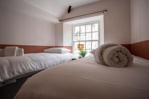 a bedroom with two beds and a window at The Bottles Lodge in Alnwick