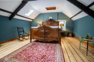 a bedroom with a bed and a rug on a wooden floor at The Bottles Lodge in Alnwick