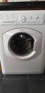 a washing machine with its door open in a kitchen at Alexandra Park House in Belfast