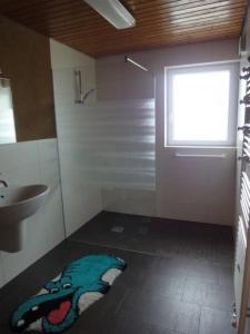 a bathroom with a sink and a rug on the floor at OG Villingendorf in Villingendorf