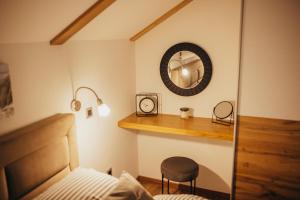 a bedroom with a bed and a mirror and a chair at Villa Magnolia in Sveti Martin na Muri +74 photos