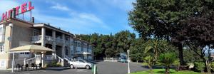 a hotel with a car parked in a parking lot at Hotel Castro in Santiago de Compostela
