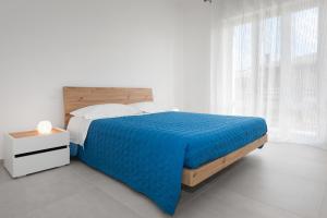 Ένα ή περισσότερα κρεβάτια σε δωμάτιο στο Civico40 Luminoso appartamento con balconi e garage privato