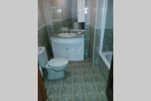 a bathroom with a toilet and a sink and a tub at CANGAS DE ONIS LUCY in Cangas de Onís +5 photos