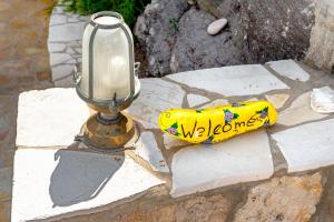 a yellow banana sitting next to a street light at Iliolousto Studios in Skala