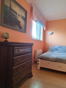 a bedroom with a dresser and a bed in it at Tähe Holiday Home in Pärnu