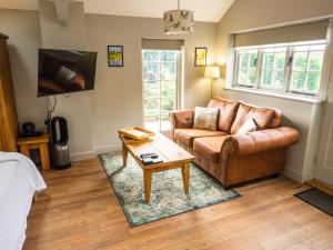 a living room with a couch and a coffee table at 1 Bed Studio in Two Dales Near Matlock & Bakewell in Two Dales