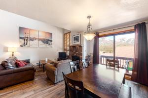 a living room with a dining room table and a couch at Cascade #54 in Durango