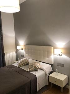 a bedroom with a large bed with a large headboard at CR Luarri in San Sebastián