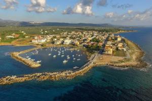 an island in the ocean with boats in the water at Harmony House Marathopoli 2 in Marathopoli