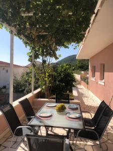 a table and chairs on a patio with a view at Apartment Hannah in Brna