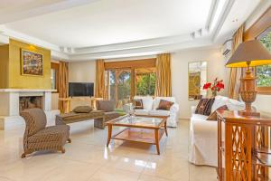 a living room with a white couch and a fireplace at Luxury Mansion Rhodes in Ialysos