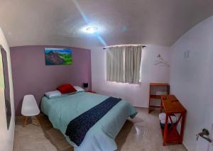 a bedroom with a bed and a light on the ceiling at ANBAROA VILLAS in Tlaxcala de Xicohténcatl