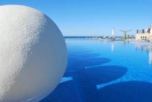 a large white ball sitting on top of a swimming pool at Encanto Living One Bedroom Unit by Kivoya in Puerto Peñasco +33 photos