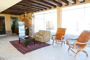 a living room with a couch and two chairs at Encanto Living One Bedroom Unit by Kivoya in Puerto Peñasco