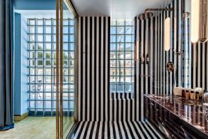a bathroom with a shower with a black and white stripes at Bazzar Boutique Hotel in Tbilisi City