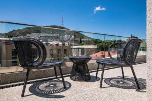 two chairs and a table on a balcony at Bazzar Boutique Hotel in Tbilisi City