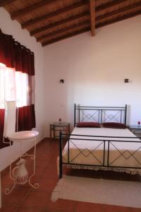 a bedroom with a bed and a table and a chair at Casa dos Avós in Alcaria