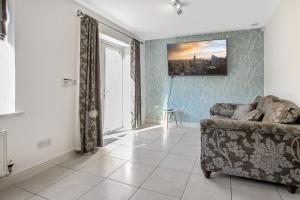 a living room with a couch and a window at Pink Sapphire Double Room with En-suite & Wifi in Derby