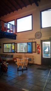 a living room with a large window and a bench at Antarctica Hostel in Ushuaia