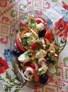 a salad on a glass plate on a table at Еко садиба в Карпатах Лостун in Dolishniy Shepit