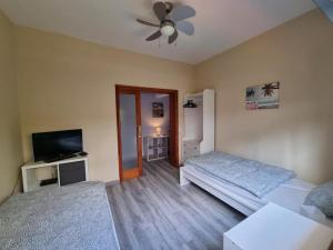 a living room with two beds and a ceiling fan at La Casa de Lucy & Karin in La Orotava