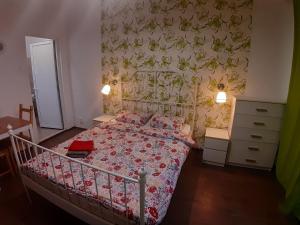 a bedroom with a bed with a floral bedspread at Romantic calm apartments piata universitate in Bucharest
