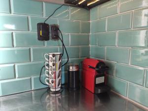 a counter top with a coffee maker and a phone at Casa Laderas de Chacras de Coria in Chacras de Coria