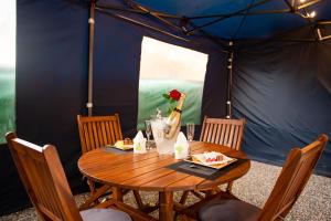 a table in a tent with a bottle of champagne at Le Jardin Secret Guyanais avec Piscine et Jardin de 70 m2 in Cayenne