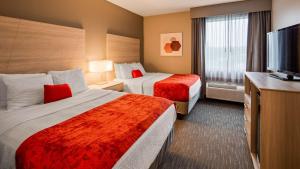 a hotel room with two beds and a flat screen tv at Best Western Plus New Cumberland in New Cumberland +22 photos