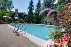 a swimming pool with a chair in front of a house at Lodge at Steamboat B205 in Steamboat Springs