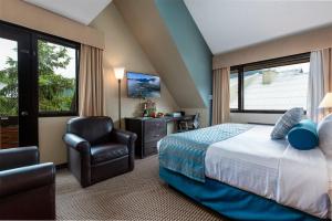 a hotel room with a bed and a chair at Blackcomb Lodge in Whistler