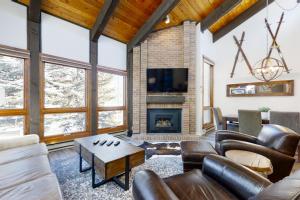a living room with leather furniture and a fireplace at Lodge at Steamboat B303 in Steamboat Springs