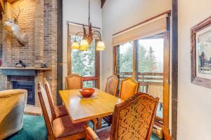 a dining room with a table and chairs and a fireplace at Lodge at Steamboat C301 in Steamboat Springs