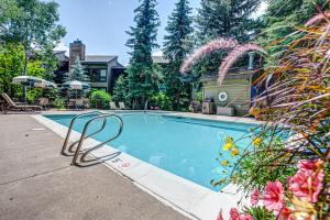 a swimming pool in front of a house at Lodge at Steamboat B104 in Steamboat Springs
