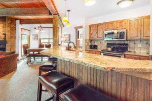 a large kitchen with a large island in a house at Lodge at Steamboat B104 in Steamboat Springs