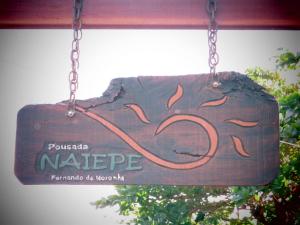 a wooden sign hanging from a chain at Pousada Naiepe in Fernando de Noronha