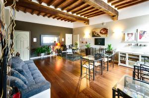 a living room with a couch and a table at Domus San Martino GuestHouse in Piacenza